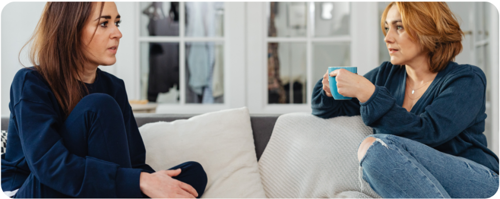 Two women talking on a sofa | share your story with loved ones